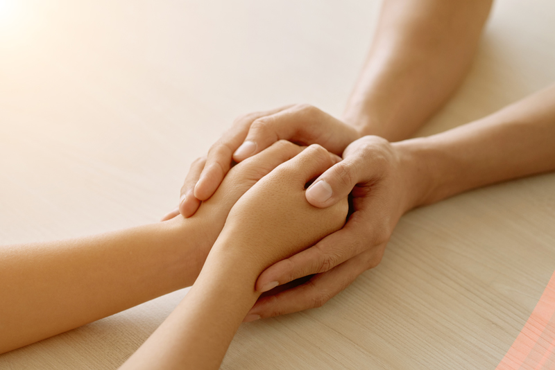 hands of anonymous supportive friend holding hands of womanjpg