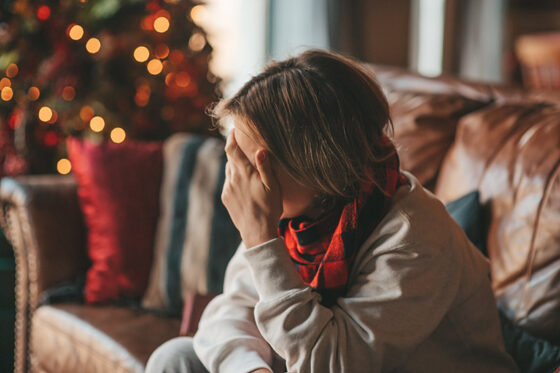 portrait candid authentic smiling boy teenager having fun emotion wooden lodge xmas decorated 560x373jpg
